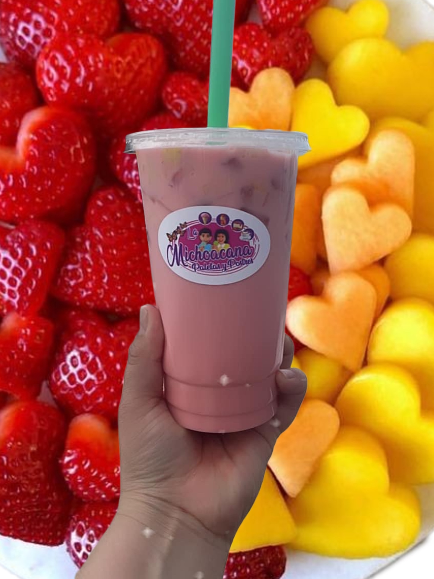 Pink strawberry agua fresca with fresh fruit